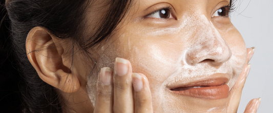 How to build a skincare routine - woman cleansing her face - what cleanser should I use?