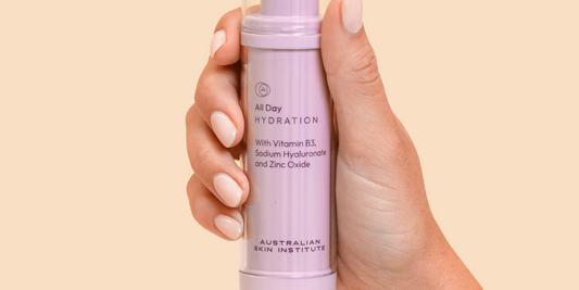 when to change your skincare routine as you get older and what key ingredients are actually going to make a difference. Picture of a hand holding a bottle of The Australian Skin Institutes All Day Hydration Moisturise on a warm beige background.