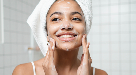 young girl with acne cleansing her skin